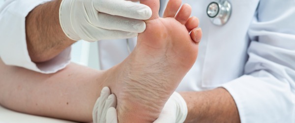A podiatrist examining a foot.