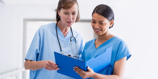 Two nurses discussing the day's duties.