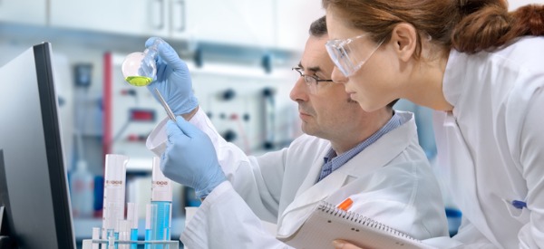 A medical laboratory technician looking at a test tube in the laboratory.