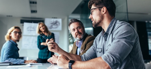 A logistician having a meeting with three co-workers.