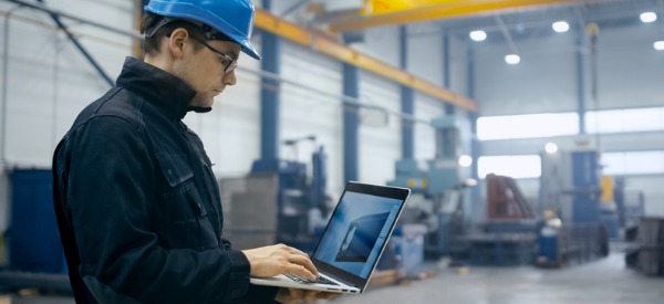 An industrial engineering technician looking at his computer.