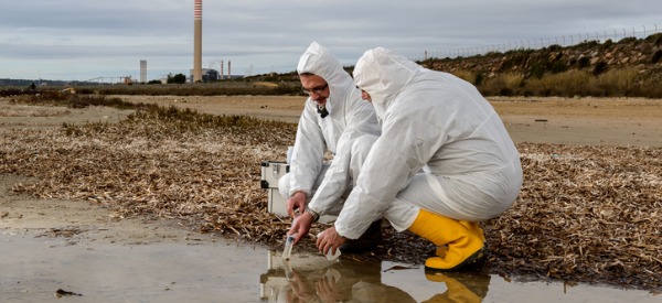 Two industrial ecologists doing field tests to investigate sources of water pollution.