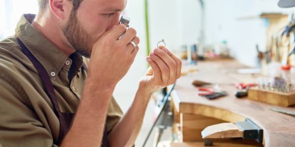 Gem workers evaluate the quality of precious gems and diamonds used in industrial settings or by private clients.