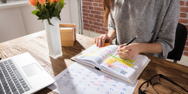 An event planner writing in her planner.