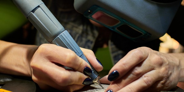 An engraver is an artist that etches specific designs, words, and even images onto different types of materials.