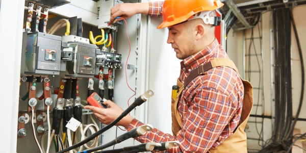 An electrical engineer checking the electrical system in an industrial plant.