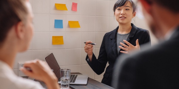 A digital marketing specialist giving a presentation to her colleagues.