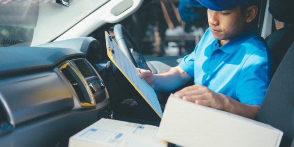 A delivery service driver picks up, transports, and drops off packages within a small region or urban area.