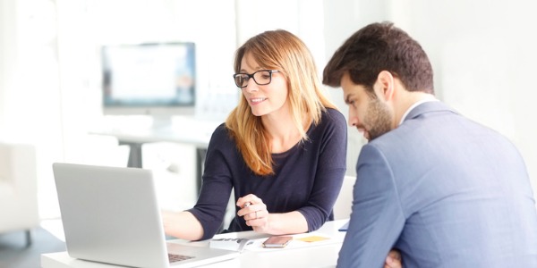 A credit counselor showing a client various ways on improving his debt.