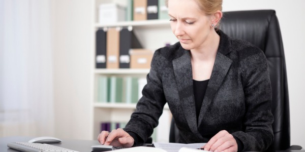 A credit analyst assessing different risk factors and collecting financial information.