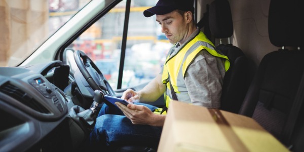 A courier transporting packages in a delivery truck.