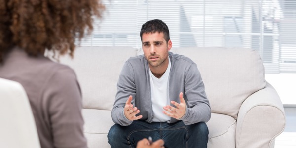 A counseling psychologist sitting with a client.