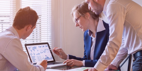 A systems analyst taking a look at a company's current computer systems and procedures.