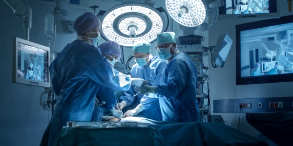 A colorectal surgeon performing surgery on a patient.