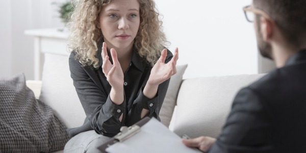 A clinical psychologist working with a patient.