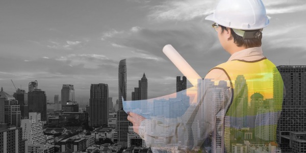 A civil engineer looking out at a city view.