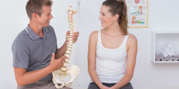 A chiropractor explaining the workings of the spine to a patient.