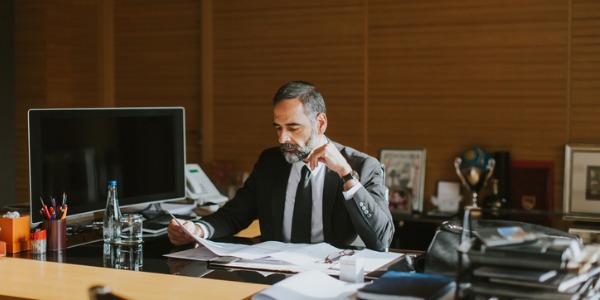 A CEO sitting at his desk and focusing on making company decisions.