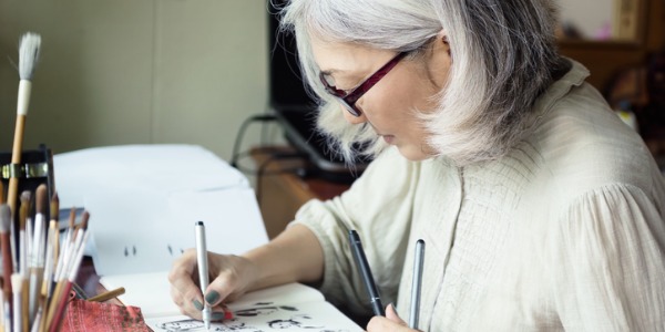 A cartoonist creating animated cartoons manually.