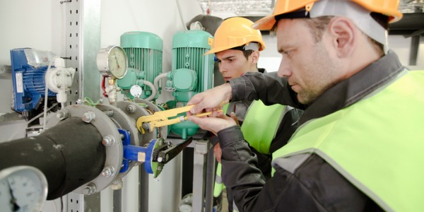 Two boilermakers repairing a boiler.
