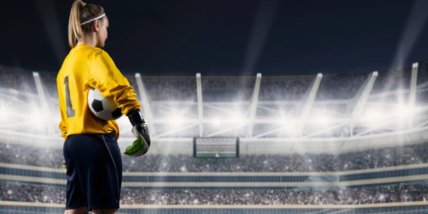 A professional athlete and soccer player waiting to start the game in an arena full of people.
