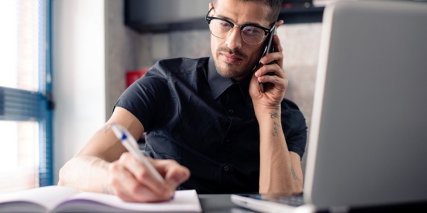 A bill and account collector talking to a debtor on the phone trying to come up with a solution that will work for both the debtor and the creditor.