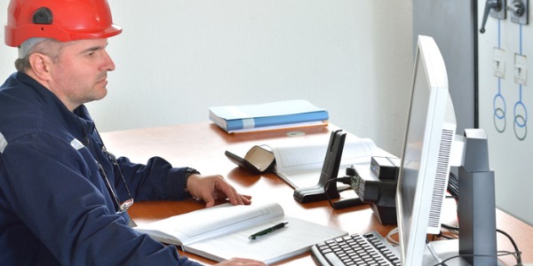 A biomass power plant manager checking on plant operations.