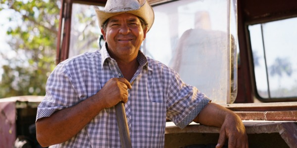 An agricultural worker outside working on a farm.