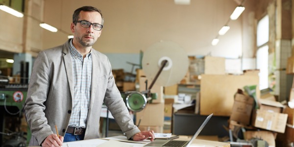 An agricultural engineer using a computer to design and develop new methods for land preparation.