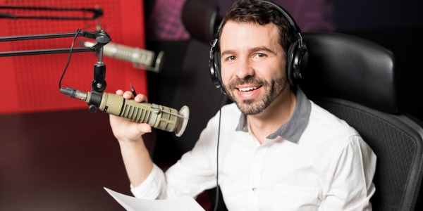 A radio announcer getting ready to present music to his listening audience.
