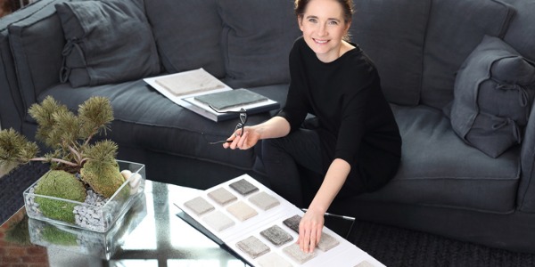 An interior designer looking a carpet swatches.