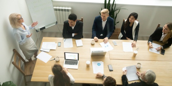 A female CEO conducting a boardroom meeting.