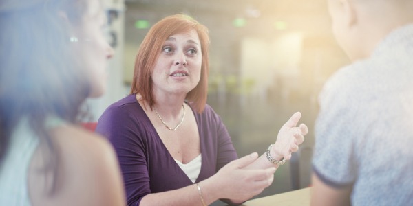 A sociologist having one-on-one conversations with people.