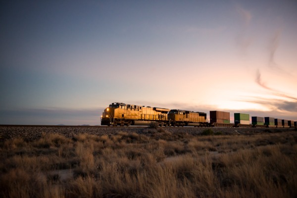 A railroad locomotive at dusk.