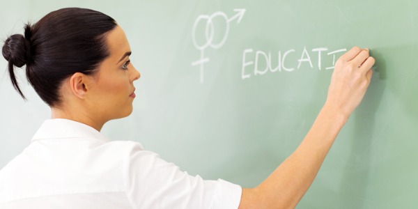 A sex educator writing on a chalkboard.