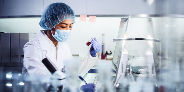 A biomedical scientist carrying out laboratory tests to diagnosis a disease.