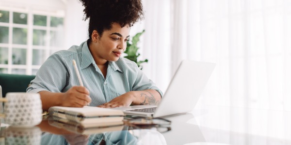 A behavioral scientist writing out her observations in order to analyze certain behaviors.