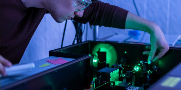 A laser technician testing laser equipment.