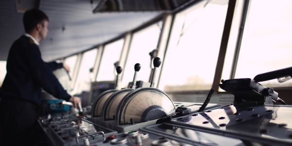 A ship captain navigating a ship.