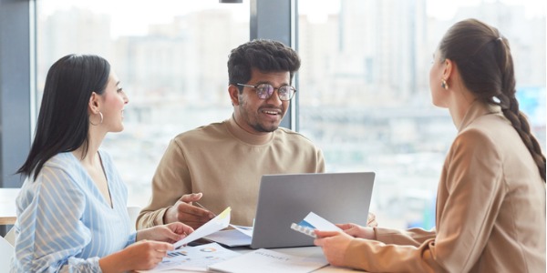 An environmental policy analyst discussing new environmental policies with two other colleagues.