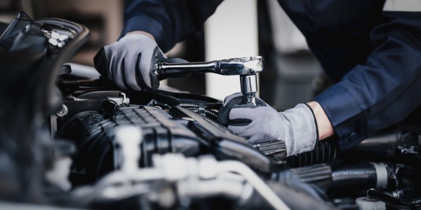 An automotive engineering technician installing automotive components.