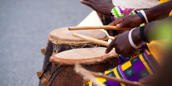 Three musicians playing bongo drums.