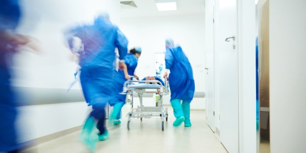 Emergency medicine physicians running to the operating room.