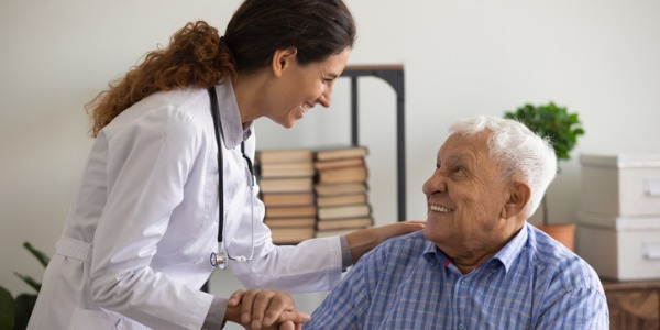 A geriatrician talking to an elderly patient.