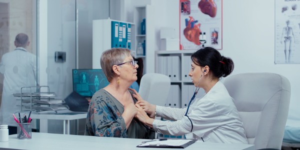 A cardiologist assessing a patient.