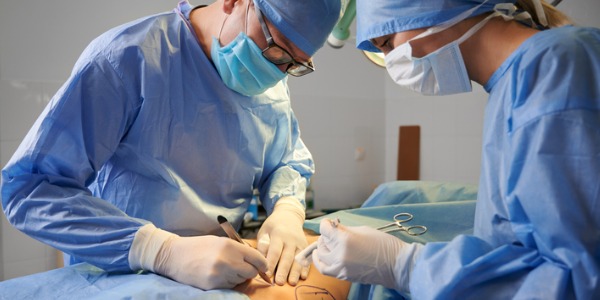 A plastic surgeon operating on a patient.