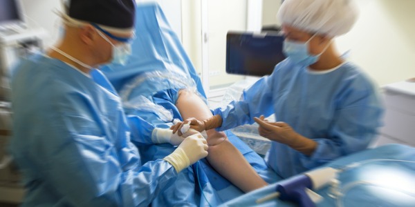 A vascular surgeon performing surgery on a patient.