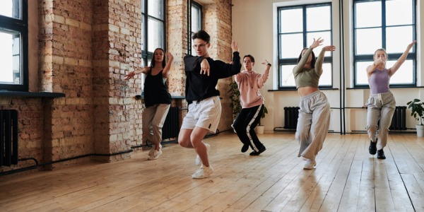 A choreographer showing dancers a new routine.
