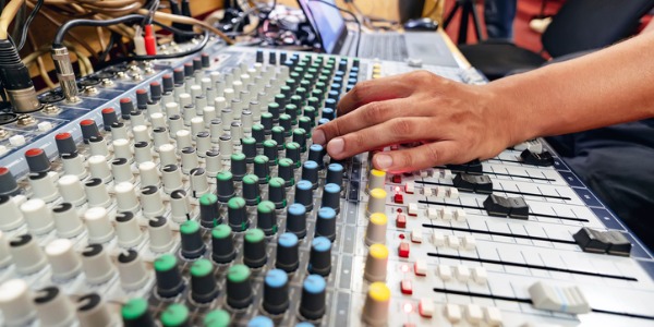 A mastering engineer enhancing the sound quality of the mix.