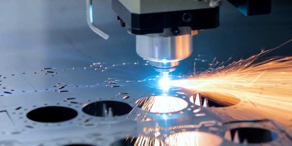 A laser making precision cuts in a metal sheet.